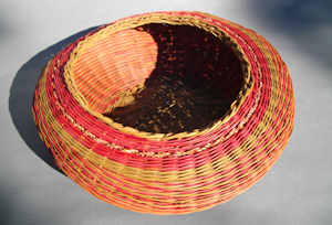 Basket made from smoked and dyed reed, dyed seagrass by Judy Goodman